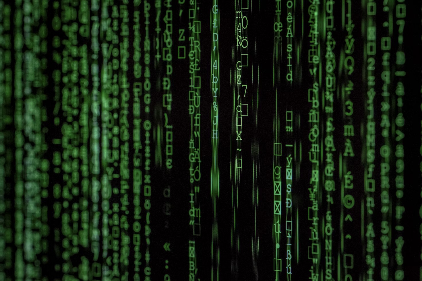 Green matrix-style code scrolling down a dark screen