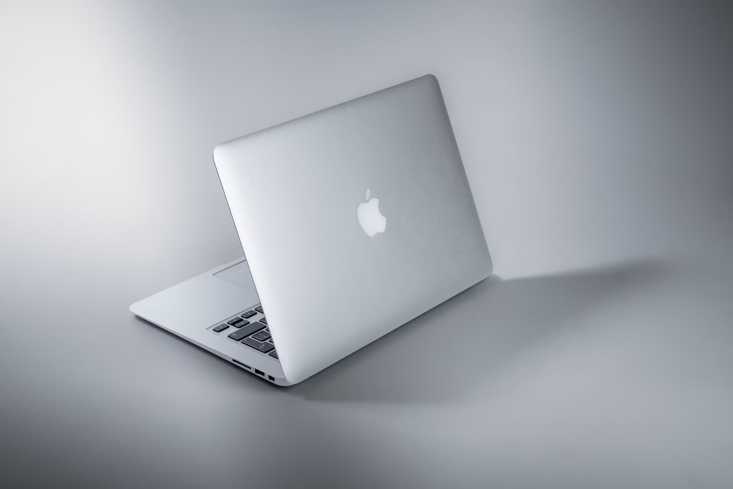 A closed MacBook on a grey background